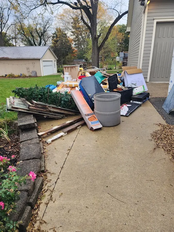 Dumpster being loaded with debris for 12 Yard Dumpster Rental in Moriah